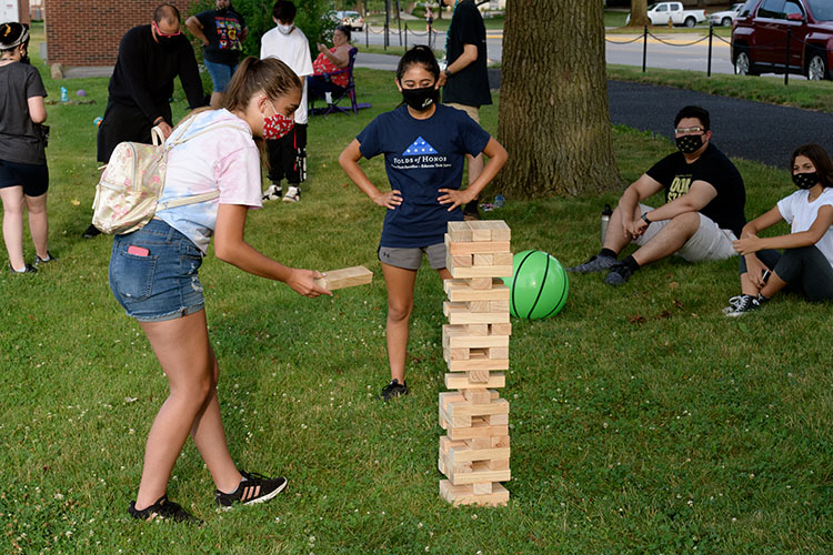 Students playing a large game of Jenga.