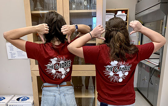 Two students with G-Force shirts facing away from the camera.