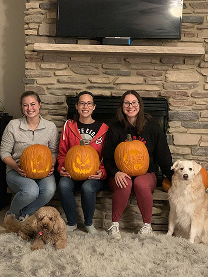 Graduate students with Halloween pumpkins.