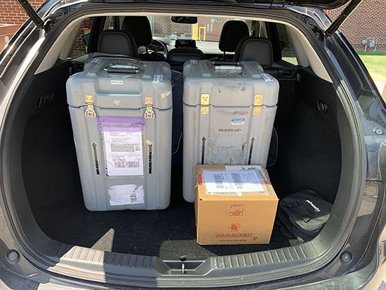 Box of supplies in the trunk of a car.