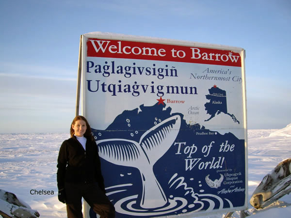 Chelsea next to the Welcome to Barrow sign
