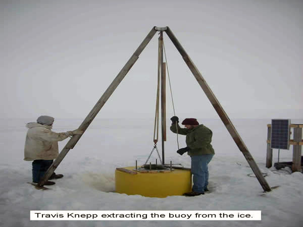 Travis Knapp extracting the buoy from the ice